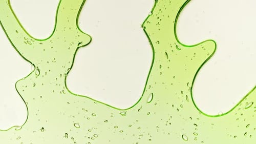Transparent Green Cosmetic Gel Fluid With Molecule Bubbles and Oil on White Background Macro Shot