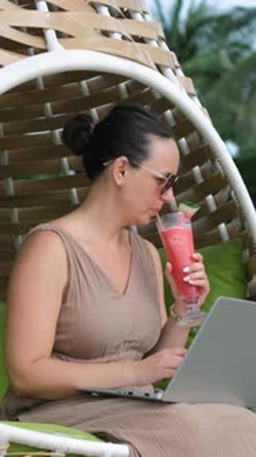Female Freelancer Relaxes and Works in Tropics