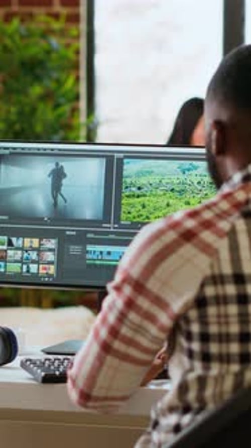 Vertical Video Male Video Editor Works From Modern Home Office in the Living Room