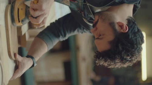 Adult Sands Wood with Tool in Workshop