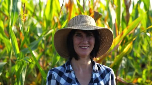 Happy Smiling Female Farmer Looks Into Camera Standing Near Corn Field Portrait of Adult Beautiful