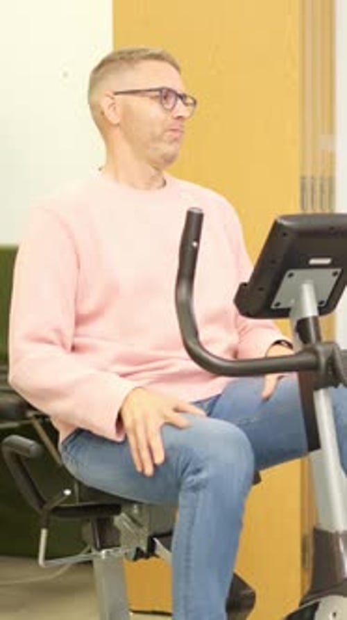 Person with a Physical Disability Training on an Exercise Bike at the Gym