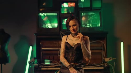 Seductive Young Adult Woman with Tattoos on Body Posing in Studio Portrait Zooming Shot From