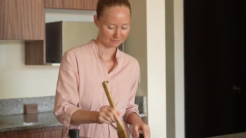 Woman Cooking and Stirring Food in Kitchen