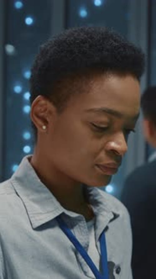 Young Smart IT Female Specialist Checking Software Working System Server Data in Data Center Storage