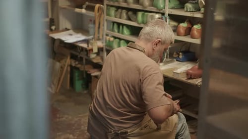 Cobbler Repairing Boots in Shoemaking Workshop
