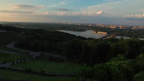 Aerial View Green Park on River Shore in Summer City. Urban Panorama