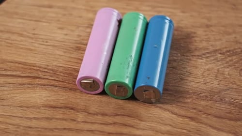 Colorful Cylindrical Batteries on Wood