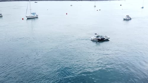 Aerial view overlooking motorboats travelling Seaside town river Conwy harbour marina