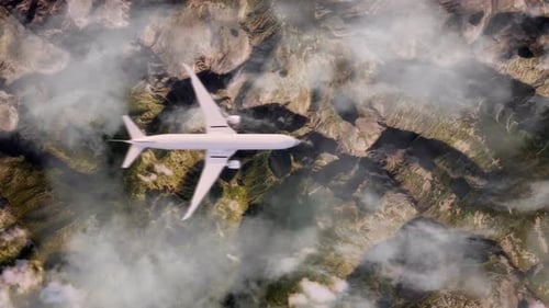 Aerial View of Airplane Flying High Above Rugged Mountain Terrain and Clouds