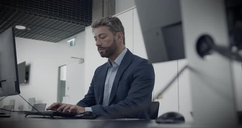 Businessman Working on Computer in Corporate Office