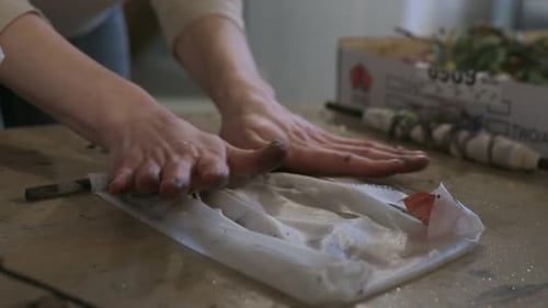 Woman Rolling Flowers for Handmade Paper