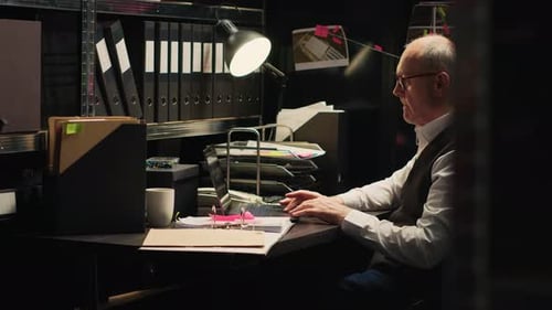 Man Working at Desk in Detective Office