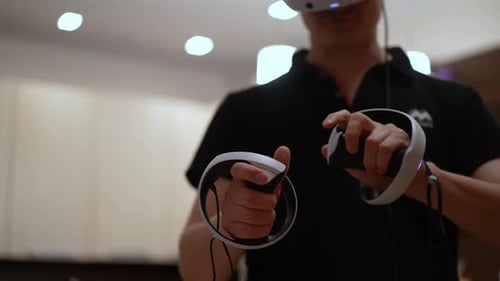Adult Using VR Headset and Controllers