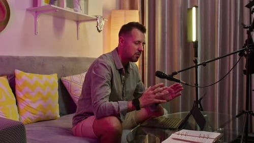 Content creator recording tutorial for his online channel from home studio.