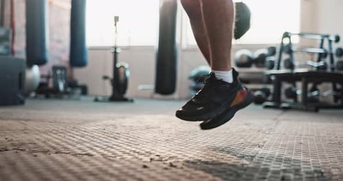 Body, skipping rope or man jumping in gym with fitness for legs, training