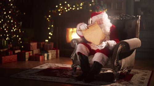 Santa Claus Reading Scroll by Cozy Fireplace at Christmas