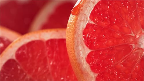 Close-up of Sliced Red Grapefruit with Water Drop