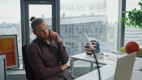 Man Talking on Phone in Modern Office