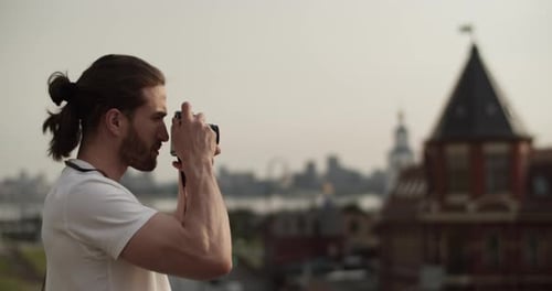 Traveling Photographer Taking Photos of Old City