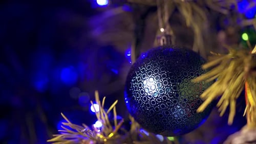 Blue Christmas Ball Ornament Hanging From Tree Branch