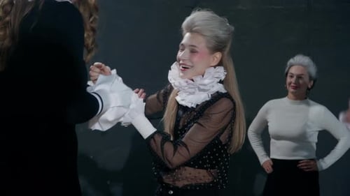 Actress Adjusting Ruffles on Elaborate Costume