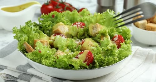 Frau isst leckeren Salat mit Croutons am Tisch, Nahaufnahme