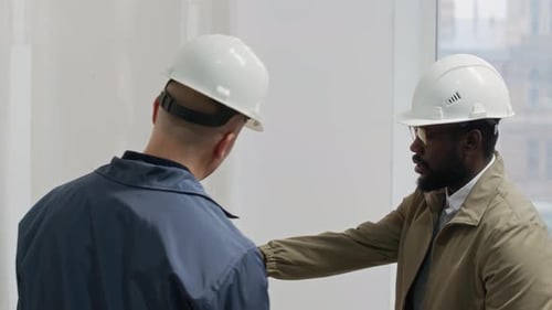 Bicultural Interior Designers Choosing Wall Color in Unfinished Office Space