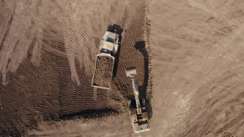 Excavator Loading Dump Truck from Above