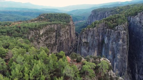 Beautiful Aerial Shots of Mountain Canyons with a Green Forest on Them