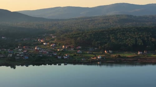 Idyllic Scenery Of Lake, Village And Mountains In Catoira, Spain - Aerial Drone Shot