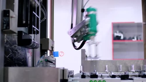 Automated robotic arm packaging medicines at pharmaceutical production plant