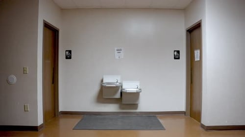 Static shot of Toilets entrance with double sink. Man and woman section, Campus building