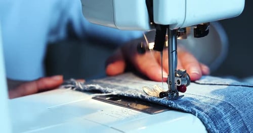 Closeup of a Woman's Hands Working on a Sewing Machine