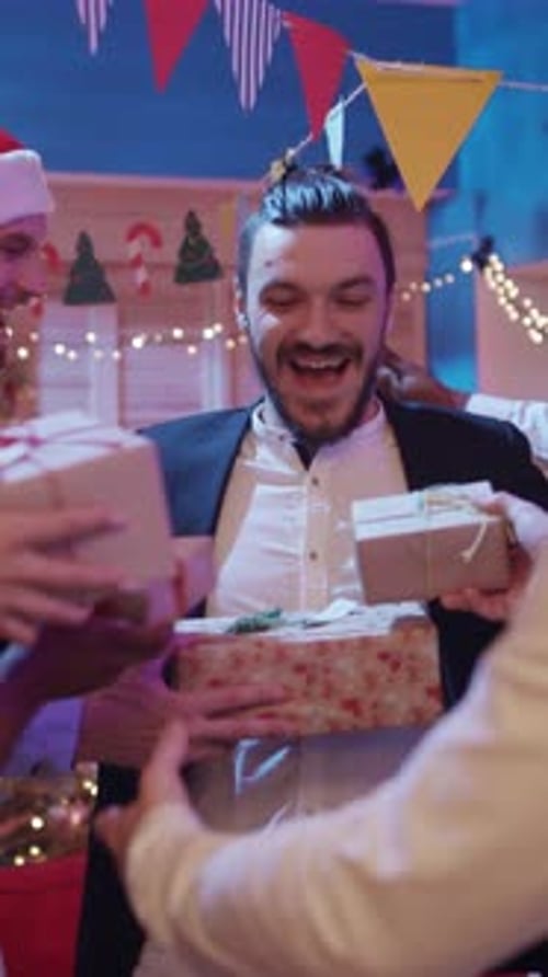 Friends Exchange Gifts During Holiday Party Celebration