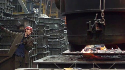 A Steel Mill Worker Demonstrates Remarkable Skills in the Essential Metal Casting Process Stock Clip