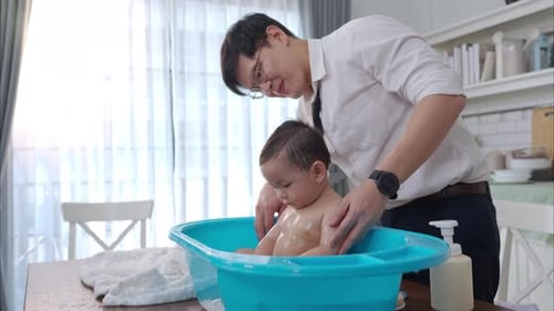 Loving Father Giving Baby a Bath