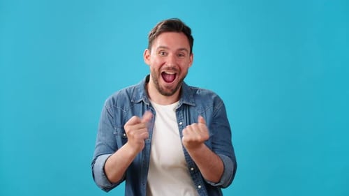 Positive Young Man Has Fun Dancing and Laughing Happily
