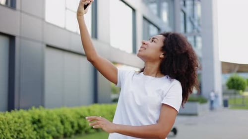 Woman Using Smartphone for Video Call Outdoors