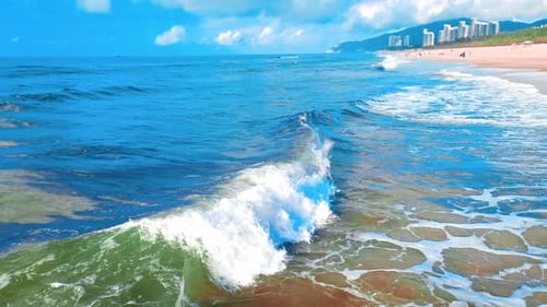 Aerial Top view of a transparent blue sea with beautiful waves at sunny day in summer. air of ocean
