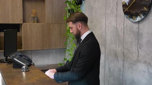 Professional Hotel Receptionist Welcoming Guest at Check in Counter