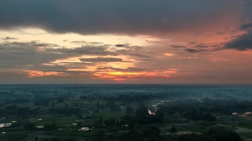 Aerial view of river and green fields at dusk, Bangladesh.