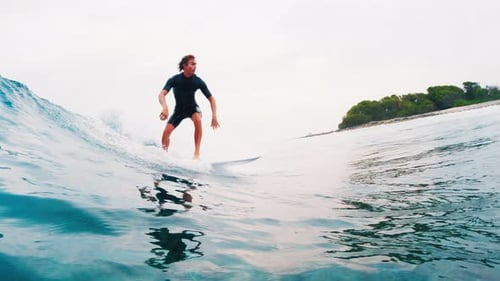 Surfing in Maldives. Man surfs the ocean wave in tropics