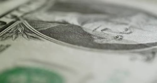 In a circular motion, a close-up of a one dollar bill bank note of the United States of America.