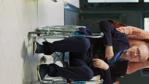 Man in Wheelchair Receiving Prescription at Clinic