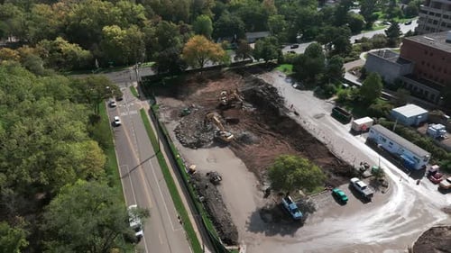 A Bulldozer Levels a Plot of Land for Construction Development Area Wide Aerial View