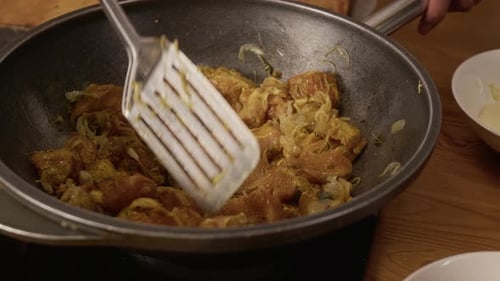 Close up of Unrecognizable Person Stirring Meat While Frying It in pan