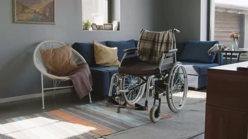 Empty Wheelchair Sitting in Comfortable Living Room