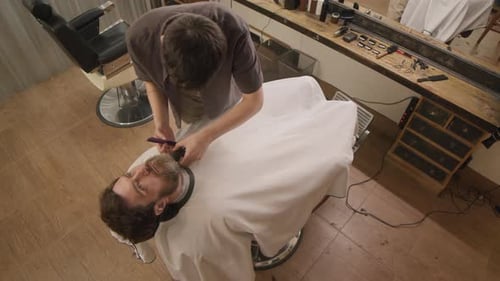 Barber Trimming Beard in Classic Barbershop
