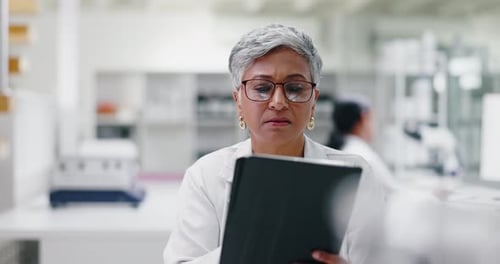 Mature Adult Using Tablet in Modern Laboratory